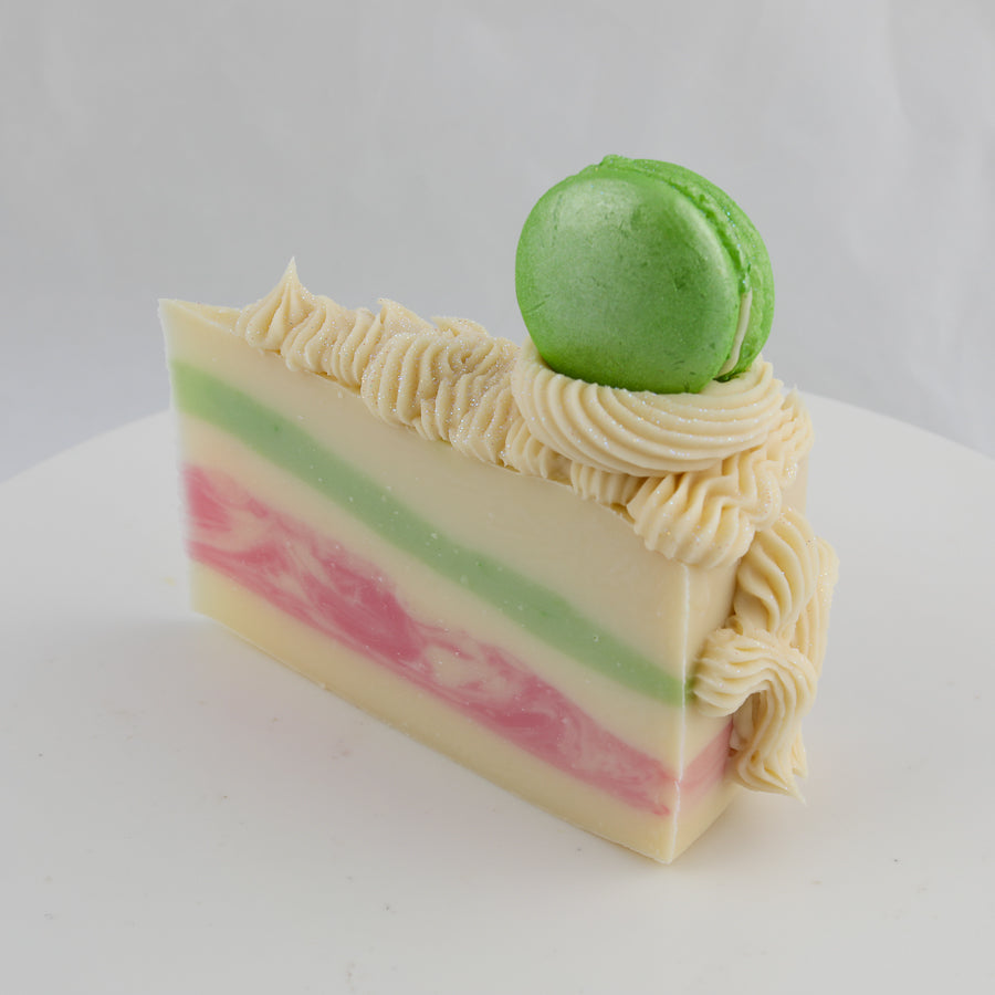 green, cream, and pink colored cake soap with a green macaroon on top