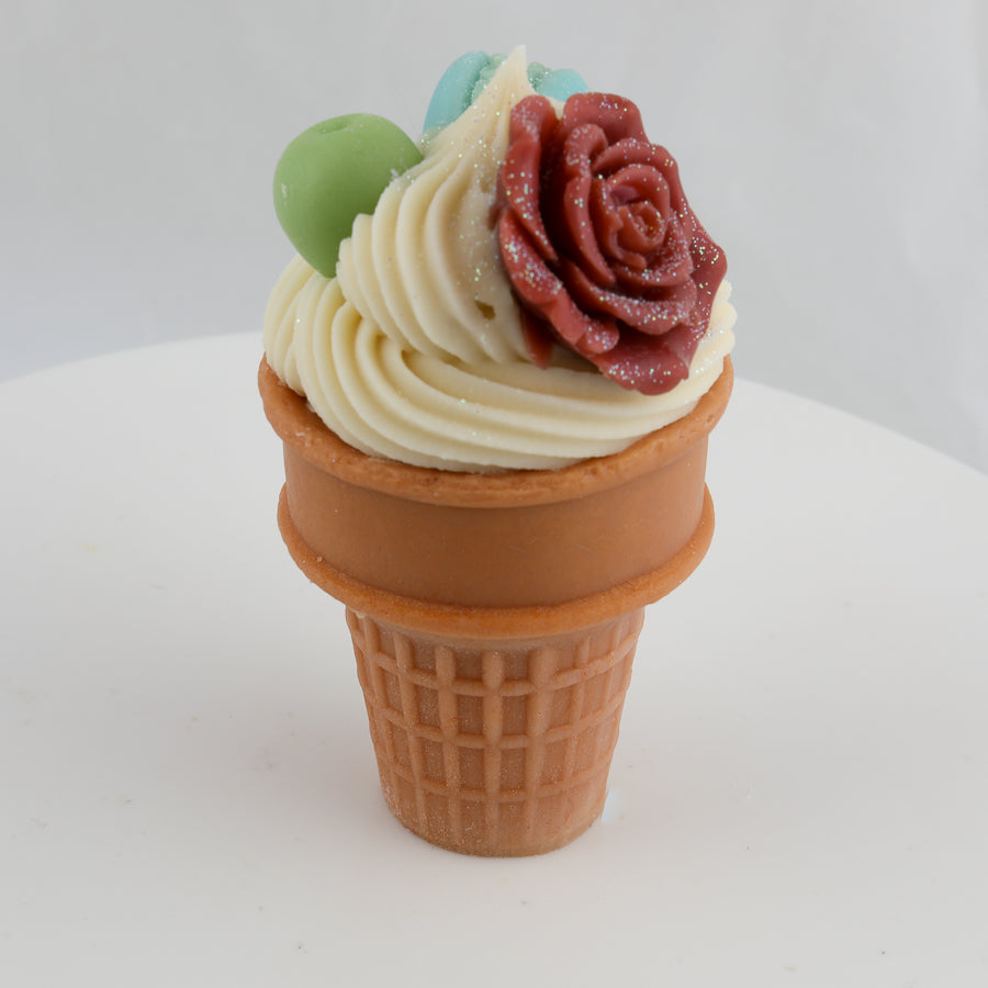 cream and brown waffle cone soap with a grape, a red rose, and a blue macaroon on top