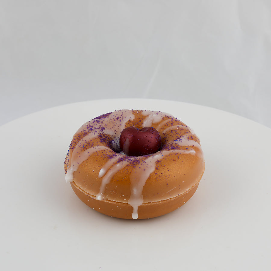 donut shaped soap with a deep red cherry in the middle