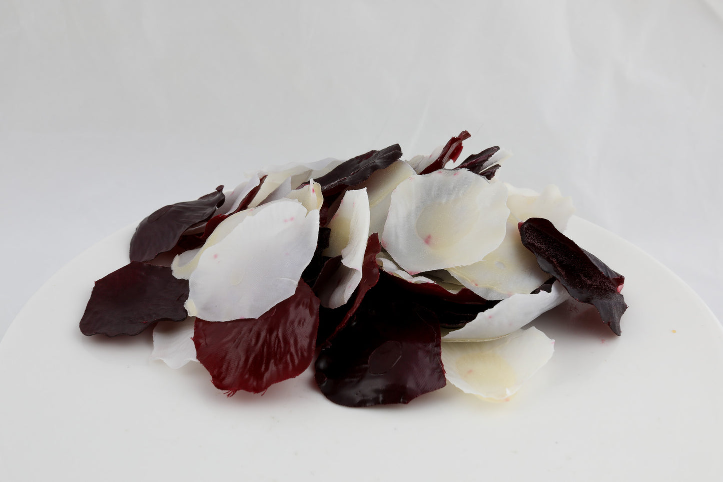 soap shaped as petals in white, maroon, and black