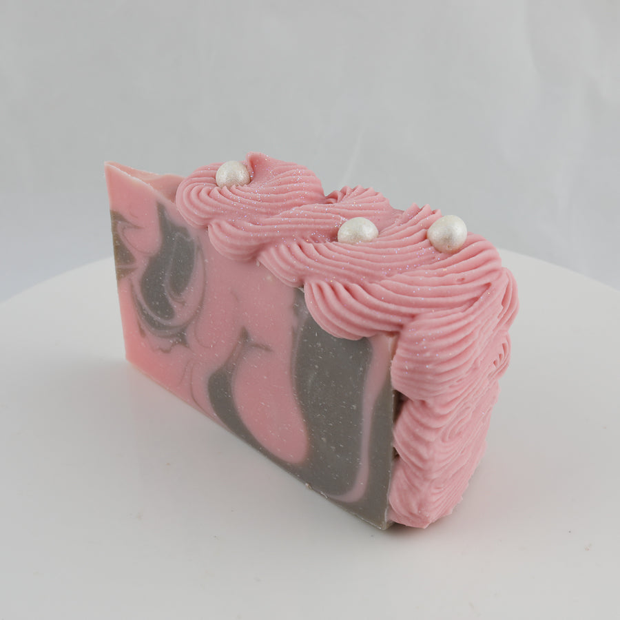 pink and grey cake shaped soap with pearls on top