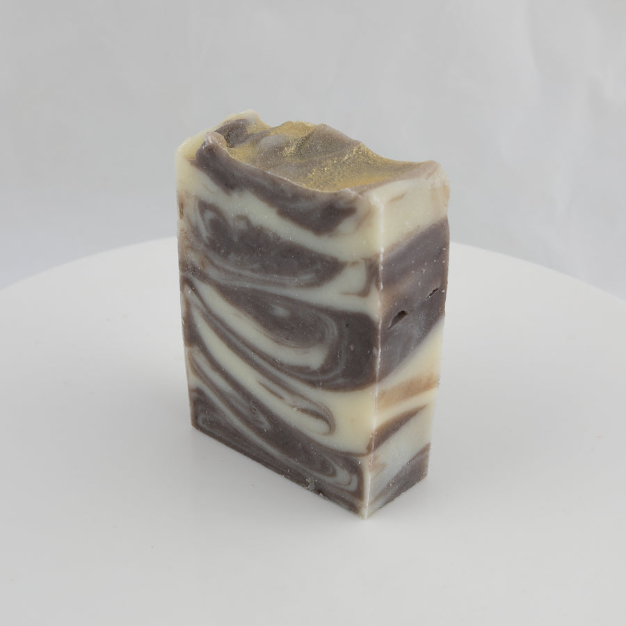 cream, brown, and gold colored swirl bar of soap