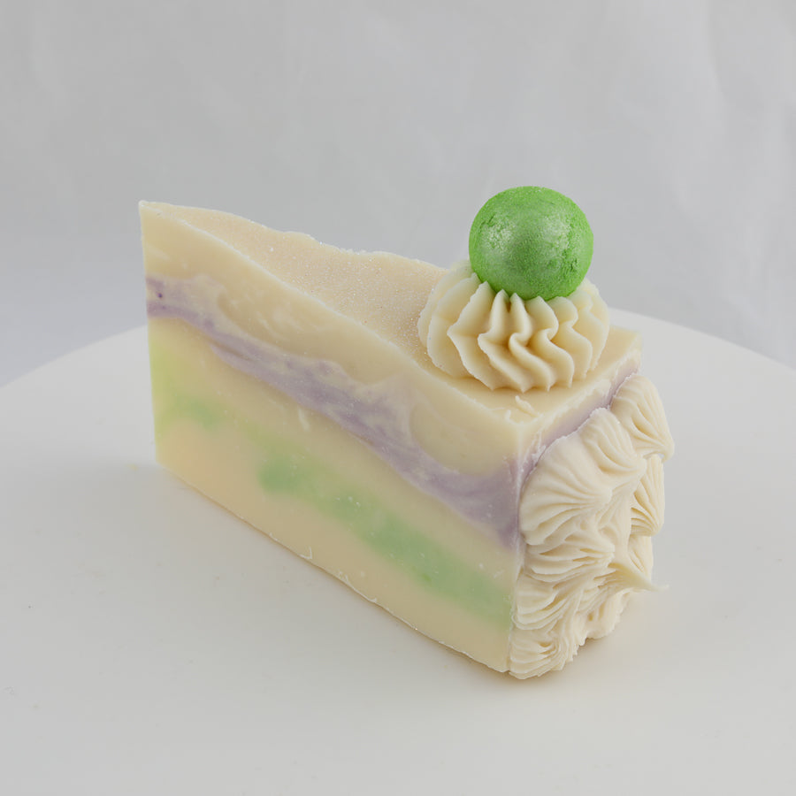 cream, purple, and green colored cake soap with an apple on top