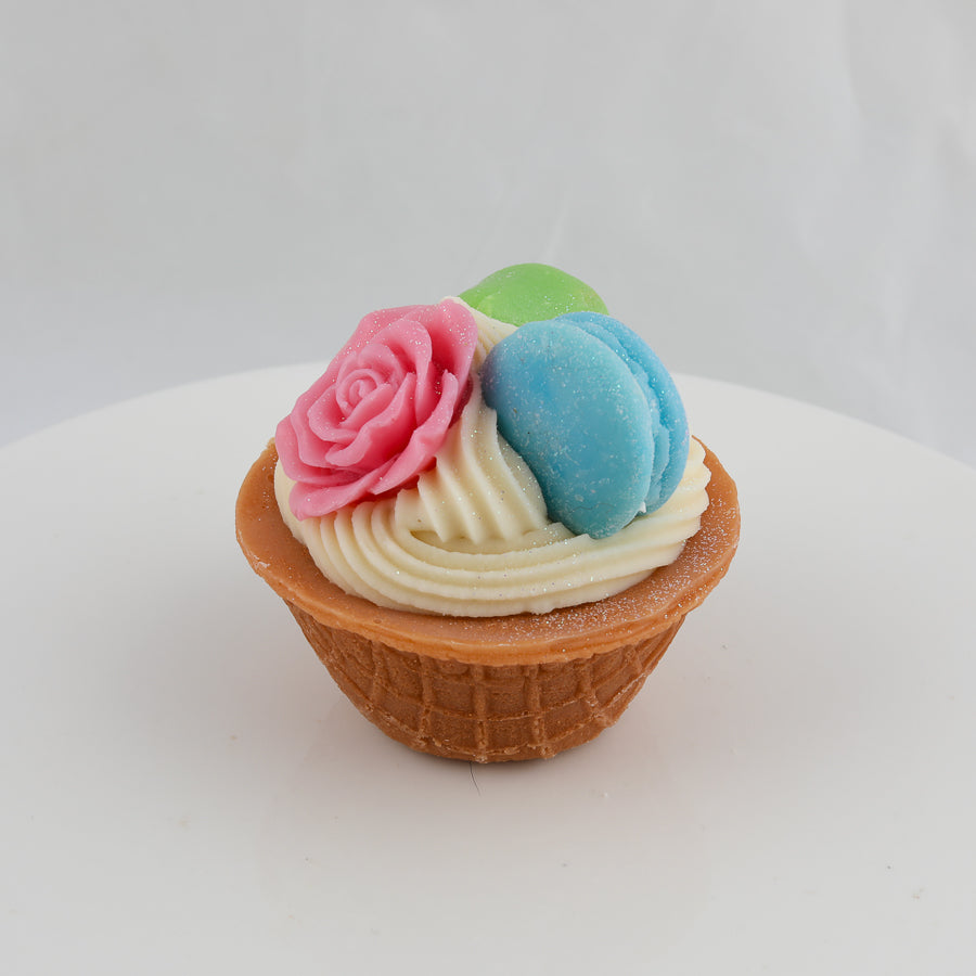 cream and brown waffle bowl with a pink rose, blue macaroon on top