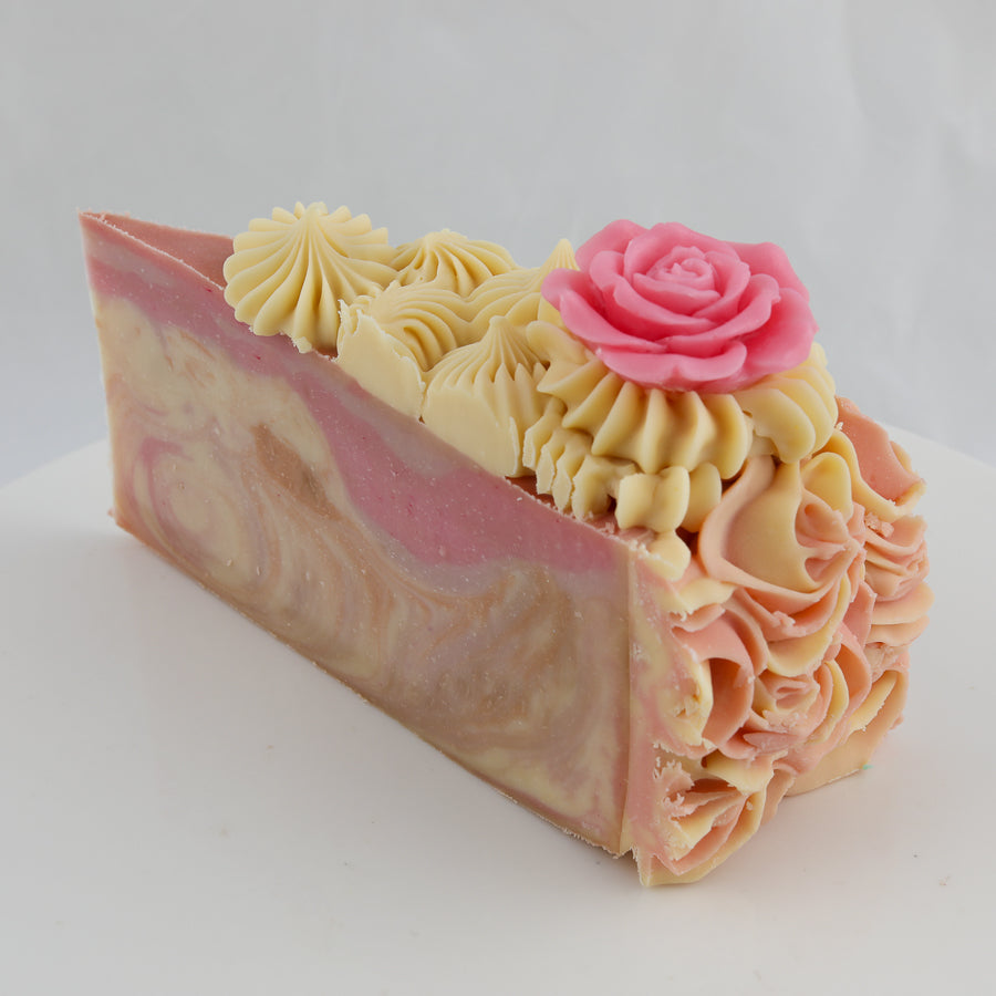 brown, pink, and cream colored cake shaped soap with roses on top