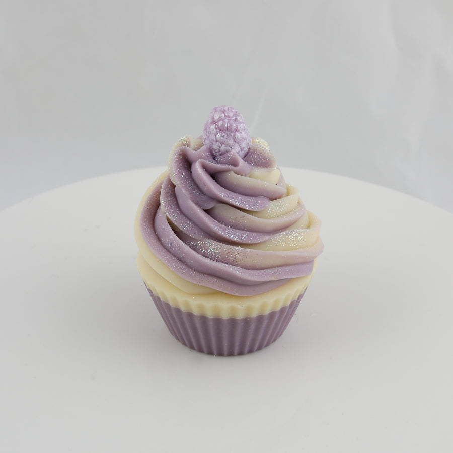 purple and cream colored, cupcake shaped soap with a purple raspberry on the top