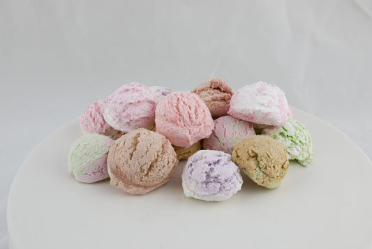 bath bomb in the shape of ice cream scoops in pink, brown, green, purple