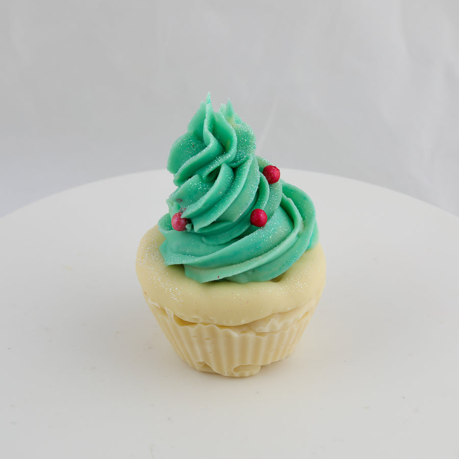 cream and green colored cupcake shaped soap with a tree shaped swirl and red balls on top