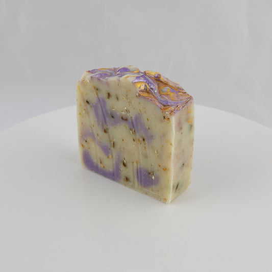 general use bar of soap with cream, purple, gold swirls and crushed oatmeal speckles