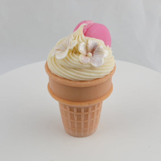 brown and cream colored ice cream cone soap with white flowers and a pink macaroon on top