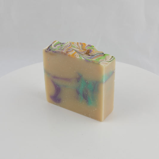 cream colored general use bar of soap with purple, turquoise, yellow and green swirls