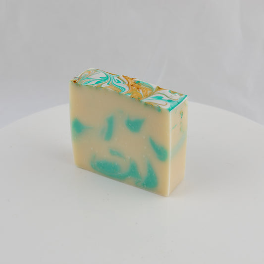 cream colored bar of general use soap with turquoise and gold swirls