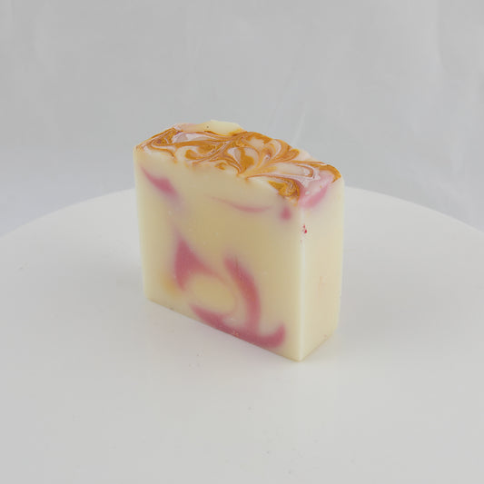 cream colored bar of general use soap with pink and gold swirls