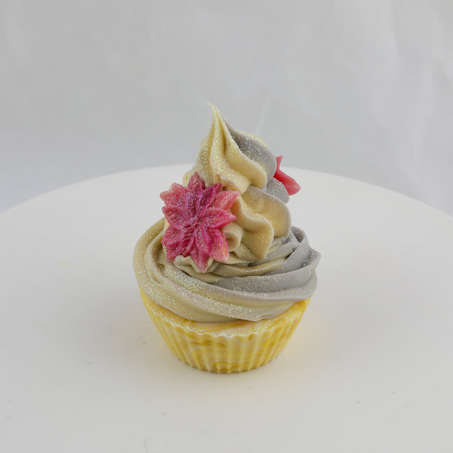 yellow, cream, and grey colored cupcake shaped soap with red pointsettias on top