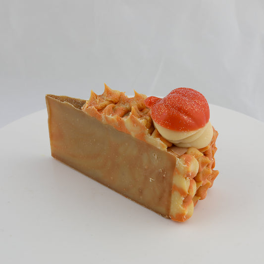 brown and orange colored cake shaped soap with a pumpkin on top. Looks like a pumpkin pie slice