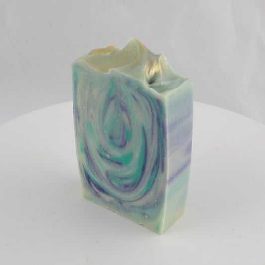 blue, green, purple, and cream swirl bar of soap