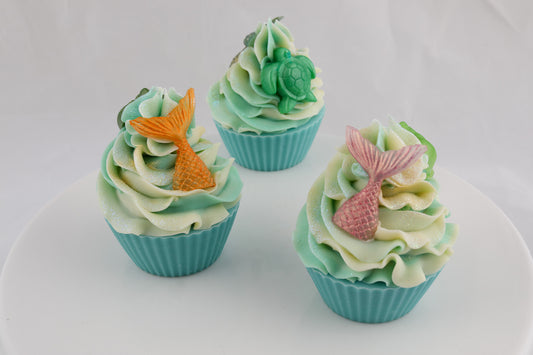 turquoise and cream colored cupcake shaped soap with mermaid tails in pink and orange and a green turtle on the top