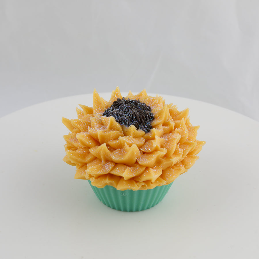 green, orange, and brown cupcake shaped soap with a sunflower on top